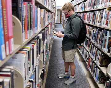 Student browsing books in Library