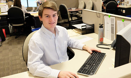 Man sitting at a cubicle desk