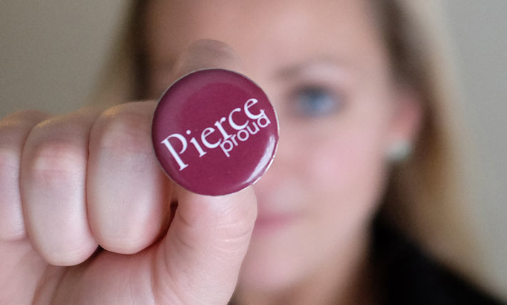 Student holds Pierce Proud button